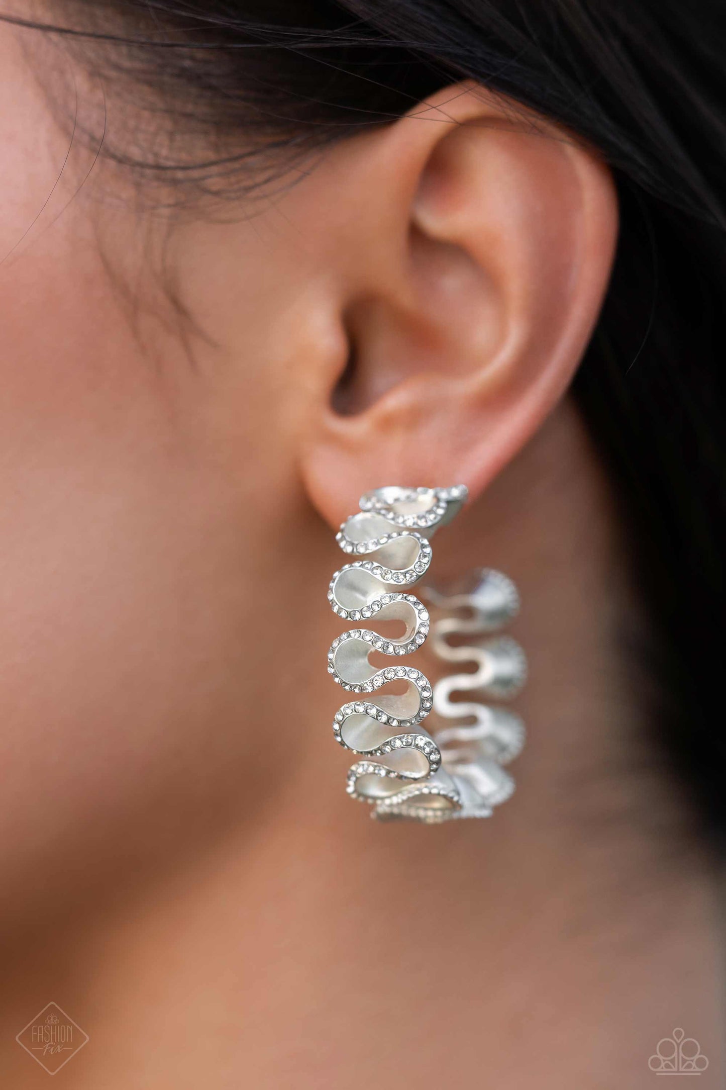Resolutely Ruffled White Hoop Earring - Paparazzi Accessories  Meticulously dotted with white rhinestones, white pearlescent-painted ribbons playfully gather around the ear for an elegant display. Earring attaches to a standard post fitting. Hoop measures approximately 1 1/2" in diameter.  Sold as one pair of hoop earrings.  Sku:  P5HO-WTXX-160SY