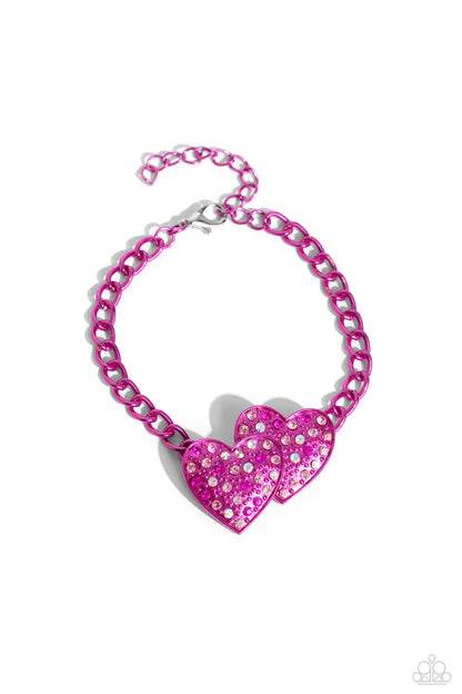 Lovestruck Lineup Pink Heart Bracelet - Paparazzi Accessories. Dipped in an electric pink hue, a strand of bulky chain gives way to two heart frames around the wrist. Dotted with tactile electric pink studs, the interlocked heart frames feature various pink and iridescent rhinestones for a timeless finish. Features an adjustable clasp closure. Sold as one individual bracelet. Get The Complete Look! Necklace: "Low-Key Lovestruck - Pink" (sold separately)