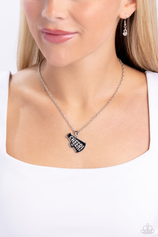 Cheer Champion Black Necklace - Paparazzi Accessories  Outlined in glistening white rhinestones, the word "Cheer!" is embossed in the center of a black-painted megaphone pendant along a dainty silver chain for a sports-inspired statement. Features an adjustable clasp closure.  Sold as one individual necklace. Includes one pair of matching earrings.  P2WD-BKXX-194XX