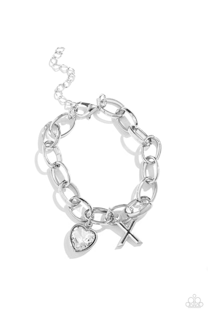 Guess Now Its INITIAL White "X" Bracelet - Paparazzi Accessories  A simple collection of silver charms — including a white rhinestone heart pressed in a silver frame and a sleek letter "X" — dance from a chunky silver chain around the wrist, creating a sentimental fringe. Features an adjustable clasp closure.  Sold as one individual bracelet.  New Kit Sku:  P9BA-WTXX-058XX