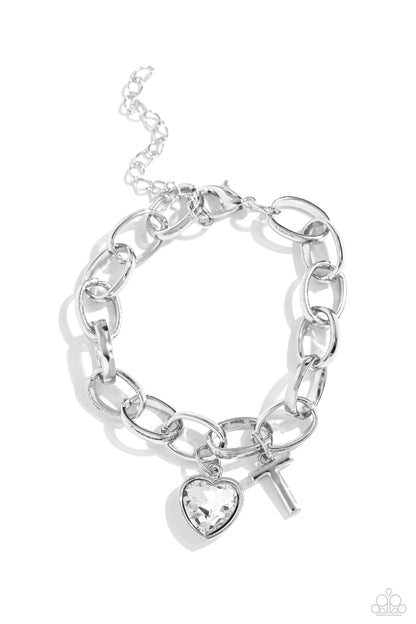 Guess Now Its INITIAL White "T" Bracelet - Paparazzi Accessories  A simple collection of silver charms — including a white rhinestone heart pressed in a silver frame and a sleek letter "T" — dance from a chunky silver chain around the wrist, creating a sentimental fringe. Features an adjustable clasp closure.  Sold as one individual bracelet.  New Kit Sku:  P9BA-WTXX-054XX