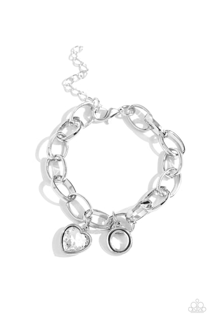 Guess Now Its INITIAL White "O" Bracelet - Paparazzi Accessories  A simple collection of silver charms — including a white rhinestone heart pressed in a silver frame and a sleek letter "O" — dance from a chunky silver chain around the wrist, creating a sentimental fringe. Features an adjustable clasp closure.  Sold as one individual bracelet.  New Kit Sku:  P9BA-WTXX-049XX