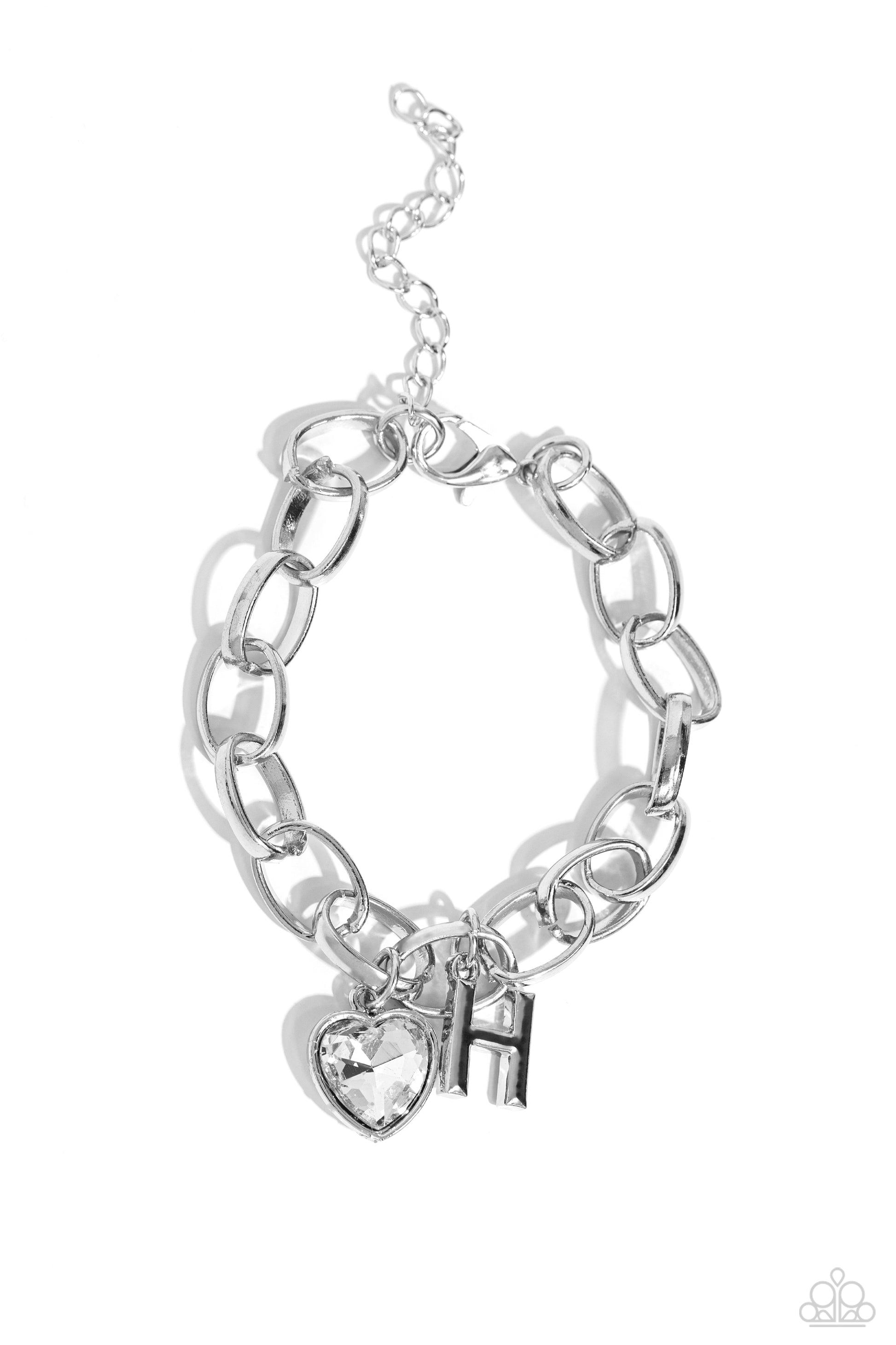 Guess Now Its INITIAL White "H" Bracelet - Paparazzi Accessories  A simple collection of silver charms — including a white rhinestone heart pressed in a silver frame and a sleek letter "H" — dance from a chunky silver chain around the wrist, creating a sentimental fringe. Features an adjustable clasp closure.  Sold as one individual bracelet.  New Kit Sku:  P9BA-WTXX-042XX