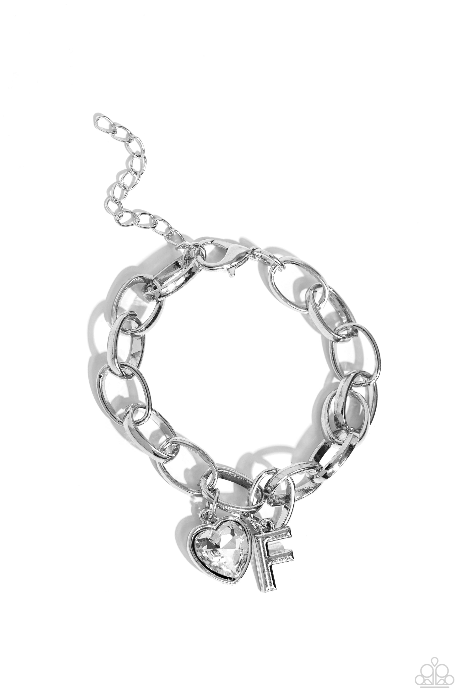 Guess Now Its INITIAL White "F" Bracelet - Paparazzi Accessories  A simple collection of silver charms — including a white rhinestone heart pressed in a silver frame and a sleek letter "F" — dance from a chunky silver chain around the wrist, creating a sentimental fringe. Features an adjustable clasp closure.  Sold as one individual bracelet.  New Kit Sku:  P9BA-WTXX-040XX