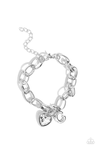 Guess Now Its INITIAL White "C" Bracelet - Paparazzi Accessories  A simple collection of silver charms — including a white rhinestone heart pressed in a silver frame and a sleek letter "C" — dance from a chunky silver chain around the wrist, creating a sentimental fringe. Features an adjustable clasp closure.  Sold as one individual bracelet.  New Kit Sku:  P9BA-WTXX-037XX
