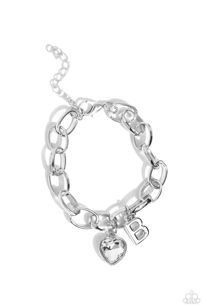 Guess Now Its INITIAL White "B" Bracelet - Paparazzi Accessories  A simple collection of silver charms — including a white rhinestone heart pressed in a silver frame and a sleek letter "B" — dance from a chunky silver chain around the wrist, creating a sentimental fringe. Features an adjustable clasp closure.  Sold as one individual bracelet.  New Kit Sku:  P9BA-WTXX-036XX