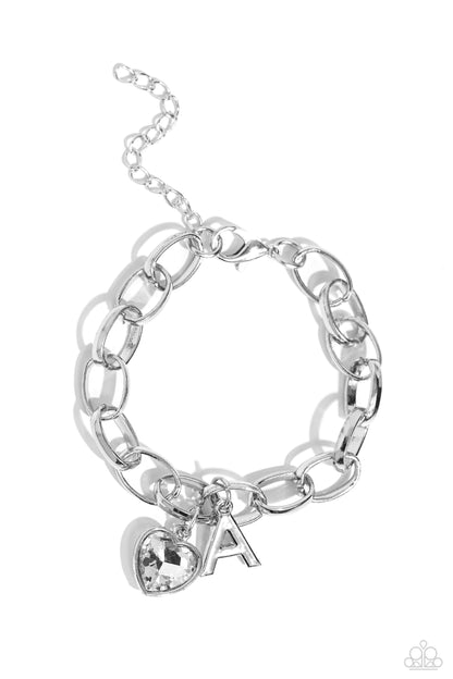 Guess Now Its INITIAL White "A" Bracelet - Paparazzi Accessories  A simple collection of silver charms — including a white rhinestone heart pressed in a silver frame and a sleek letter "A" — dance from a chunky silver chain around the wrist, creating a sentimental fringe. Features an adjustable clasp closure.  Sold as one individual bracelet.  New Kit Sku:  P9BA-WTXX-035XX