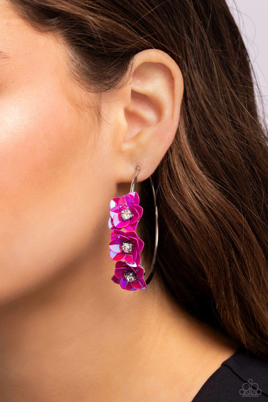Ethereal Embellishment Pink Flower Hoop Earring - Paparazzi Accessories  A trio of Fuchsia Fedora flowers, featuring an iridescent sheen and dotted with white pronged rhinestone centers, blossoms atop a thin silver hoop for a dreamy, whimsical finish. Earring attaches to a standard post fitting. Hoop measures approximately 2 1/2" in diameter. Due to its prismatic palette, color may vary.  Sold as one pair of hoop earrings.  Sku:  P5HO-PKXX-075XX