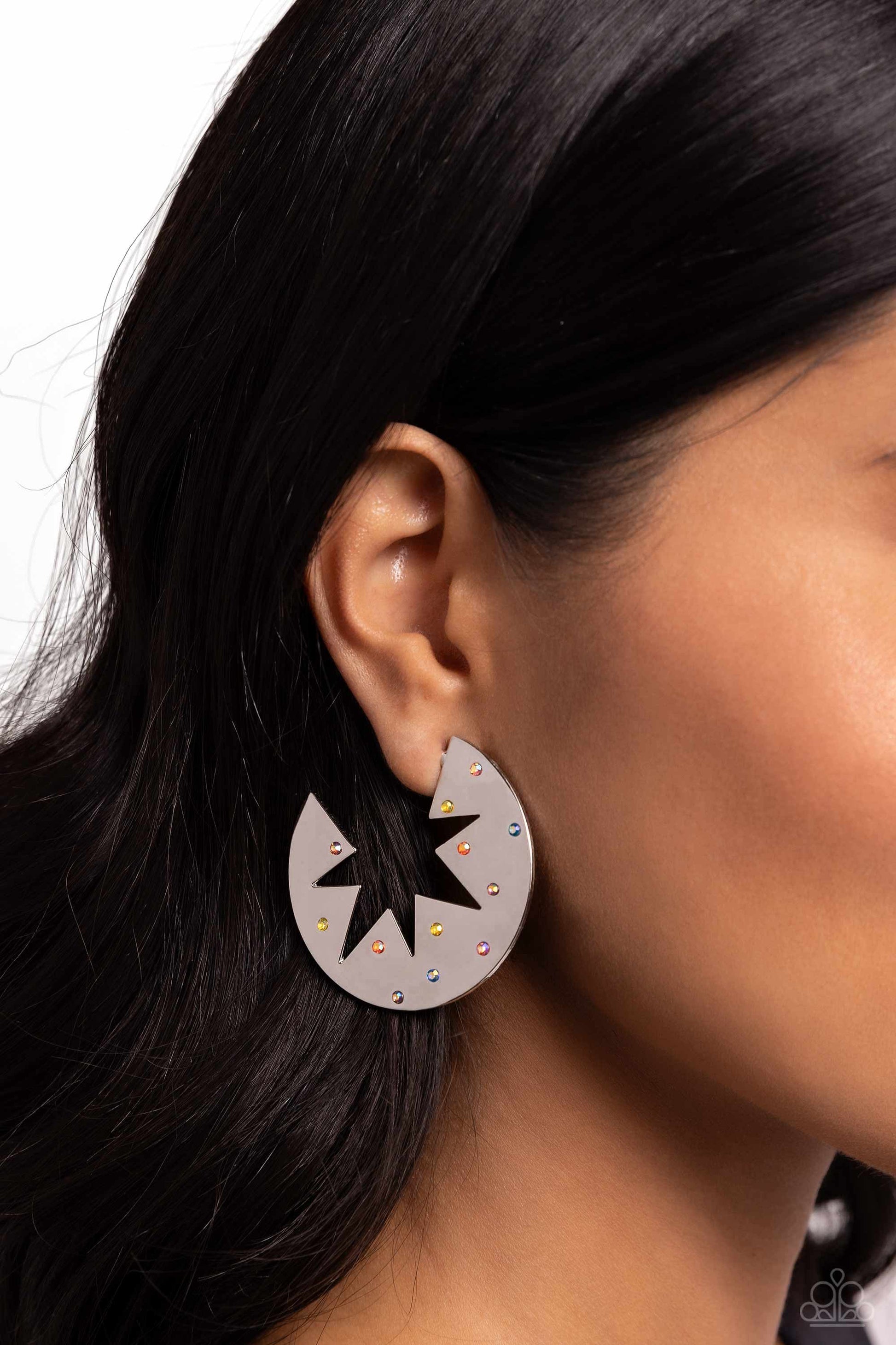 Starry Sensation Multi Star Hoop Earring - Paparazzi Accessories  Sporadically dotted with various multicolored and iridescent rhinestones, a three-dimensional star outline explodes from the center of a polished silver disc for an out-of-this-world centerpiece. Earring attaches to a standard post fitting. Hoop measures approximately 1 3/4" in diameter. Due to its prismatic palette, color may vary.  Sold as one pair of hoop earrings.  Sku:  P5HO-MTSV-324XX
