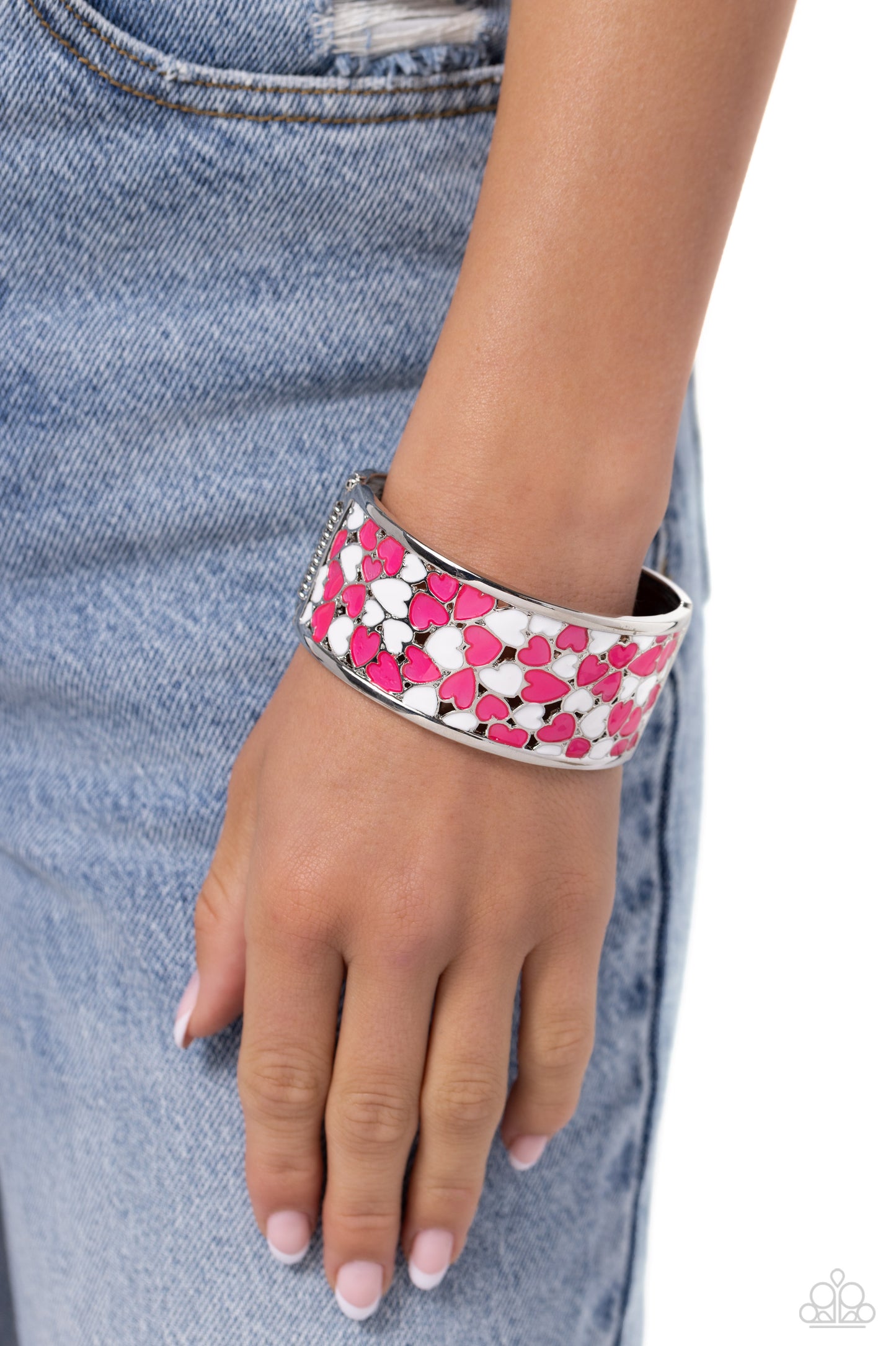 Penchant for Patterns Pink Heart Hinge Bracelet - Paparazzi Accessories  A wide silver band, hammered with subtle texture, is sprinkled with a collection of hot pink and white-painted hearts, creating a fun-loving display around the wrist. Features a hinged closure.  Sold as one individual bracelet.  SKU: P9WH-PKXX-332XX