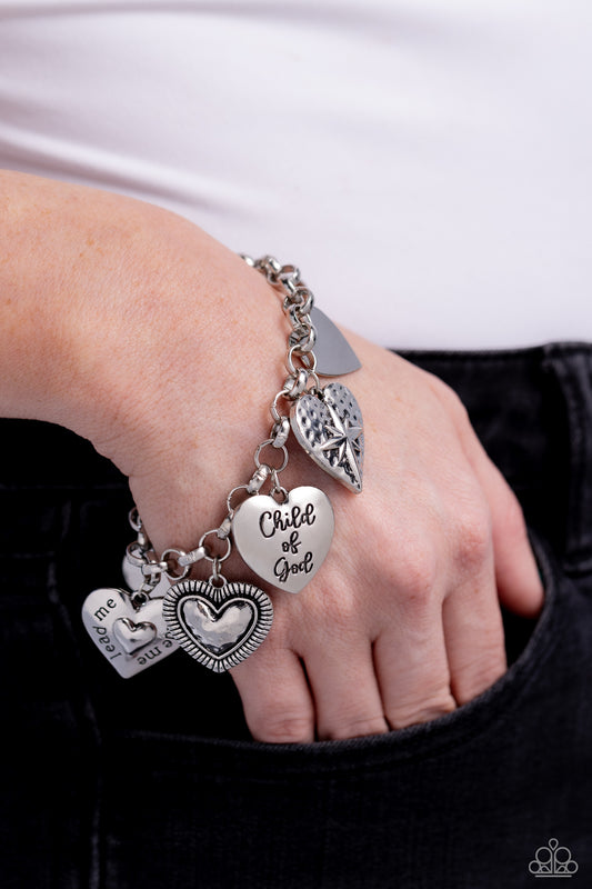 Child of God Silver Inspirational Bracelet - Paparazzi Accessories  A whimsical collection of silver heart charms — featuring hammered, diamond-cut, and smooth textures — dance from a silver chain around the wrist, creating a boisterous fringe. Two of the hearts feature the phrases "Child of God" and "'Lead Me, Guide Me" for a religious-inspired finish. Features an adjustable clasp closure.  Sold as one individual bracelet.  Sku:  P9WD-SVXX-237XX