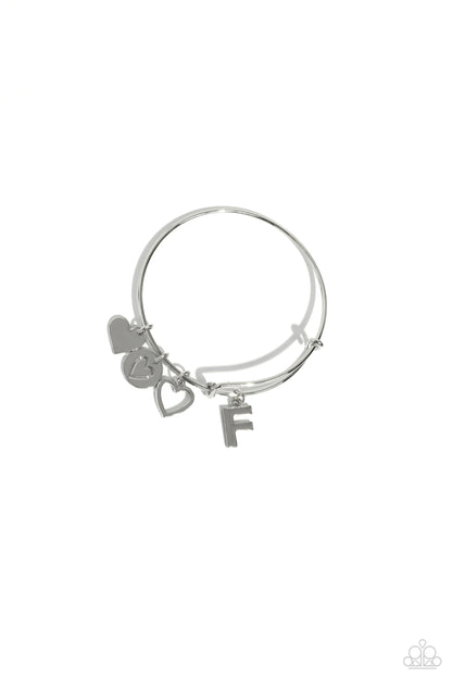 Making It INITIAL Silver "F" Bracelet - Paparazzi Accessories  Featuring shiny silver, airy, and stamped finishes, a mismatched collection of dainty heart charms, and the letter "F" glides along a silver bar fitting at the center of the wrist for a romantic, sentimental flair.  Sold as one individual bracelet.  SKU: P9BA-SVXX-190XX