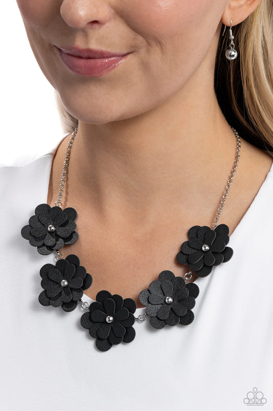 Balance of FLOWER Black Necklace - Paparazzi Accessories   Featuring silver stud centers, a collection of 3D black leather flowers connect to a classic silver chain for a ruggedly retro look. Features an adjustable clasp closure. Sold as one individual necklace. Includes one pair of matching earrings.  SKU: P2WH-BKXX-324XX