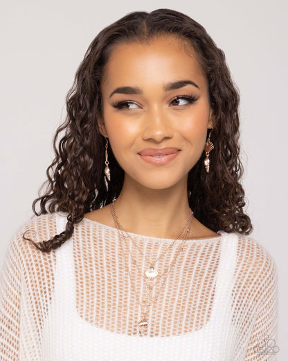 Seashell Sonata Rose Gold Necklace - Paparazzi Accessories A mismatched collection of dainty rose gold and satellite rose gold chains loop and layer below the neckline. Dangling along each layer, textured rose gold seashells and a starfish create a coastal centerpiece. Features an adjustable clasp closure. Sold as one individual necklace. Includes one pair of matching earrings. SKU: P2SE-GDRS-133WO Earring: "SHELL, I Was In the Area - Rose Gold" (Sold Separately)