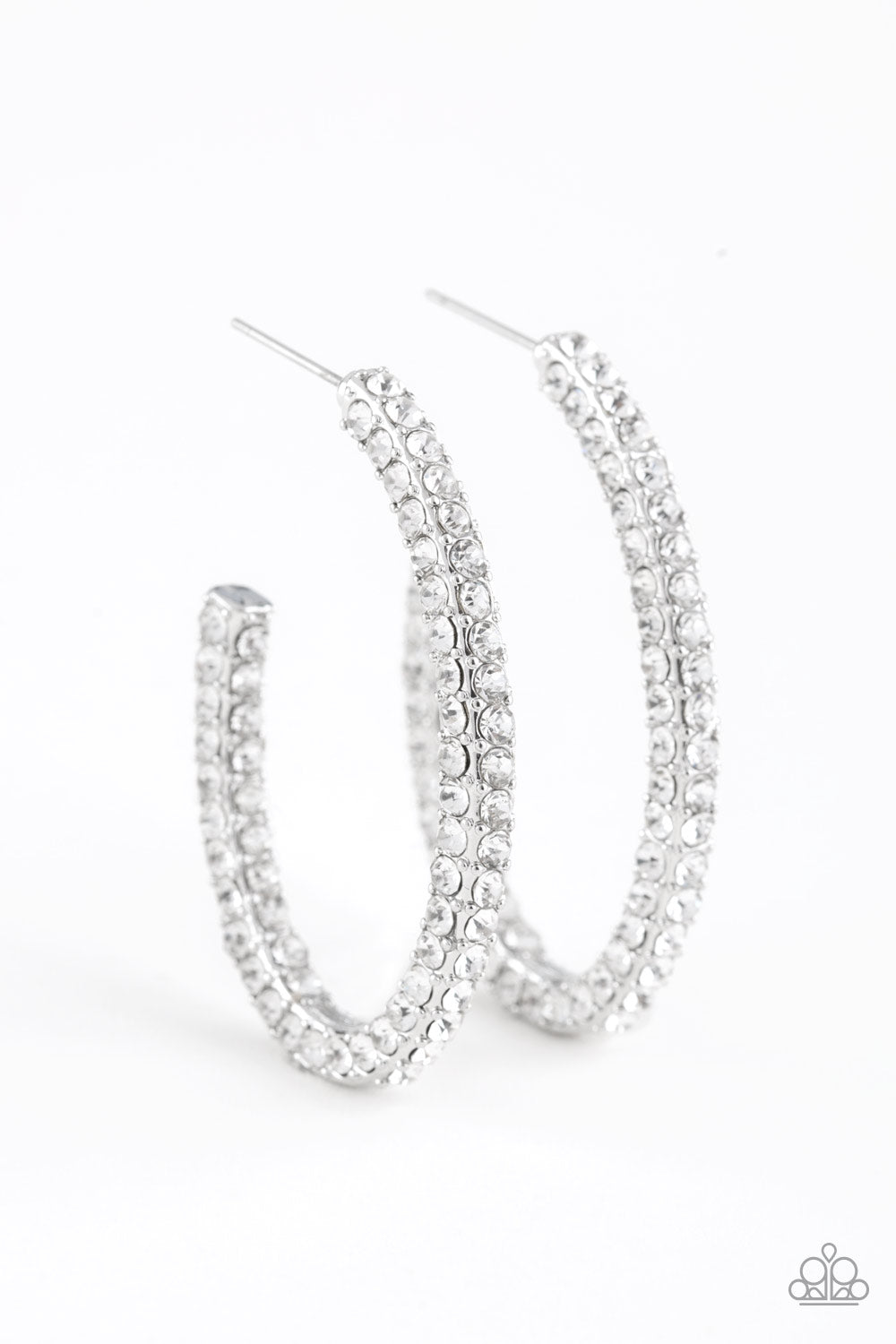 Big Winner - White Item #E385 Glassy white rhinestones are encrusted along three sides of an abstract silver hoop for a glamorous look. Earring attaches to a standard post fitting. Hoop measures 1" in diameter. All Paparazzi Accessories are lead free and nickel free!  Sold as one pair of hoop earrings.