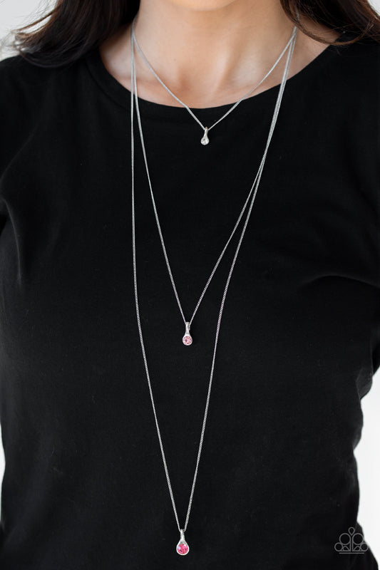 Crystal Chic - Pink Item #JJG-N679 Gradually increasing in size as they drip down the chest, a trio of white, light pink, and pink rhinestone pendants trickle from the bottoms of layered silver chains for a delicate ombre effect. Features an adjustable clasp closure. All Paparazzi Accessories are lead free and nickel free!  Sold as one individual necklace. Includes one pair of matching earrings.