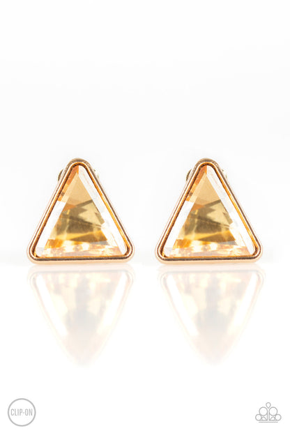 Timeless In Triangles - Gold Item #E156 Featuring a triangle-cut, a golden gem is pressed into a sleek gold frame for a timeless look. Earring attaches to a standard clip-on fitting. All Paparazzi Accessories are lead free and nickel free!  Sold as one pair of clip-on earrings.