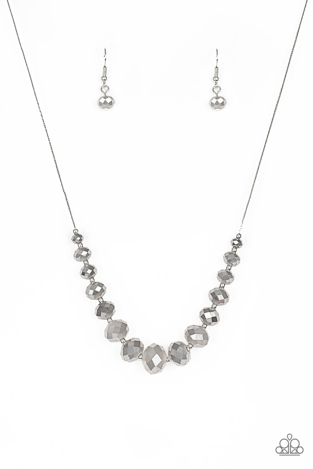 Crystal Carriages - Silver Item #N746 Brushed in a metallic finish, iridescent crystal-like beads and dainty silver beads are threaded along a flat silver chain below the collar. The sparkling crystal-like beads gradually increase in size near the center for a refined finish. Features an adjustable clasp closure. All Paparazzi Accessories are lead free and nickel free!  Sold as one individual necklace. Includes one pair of matching earrings.