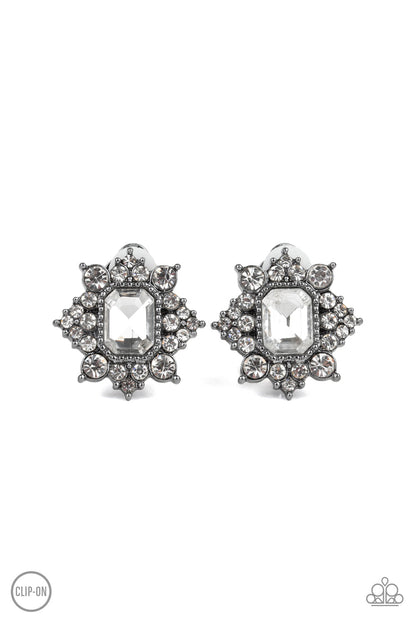 Interstellar Sparkle - Black Item #E324 Featuring sleek gunmetal fittings, dainty white rhinestones coalesce around a glittery white emerald style rhinestone center for a stellar look. Earring attaches to a standard clip-on fitting. All Paparazzi Accessories are lead free and nickel free!  Sold as one pair of clip-on earrings.