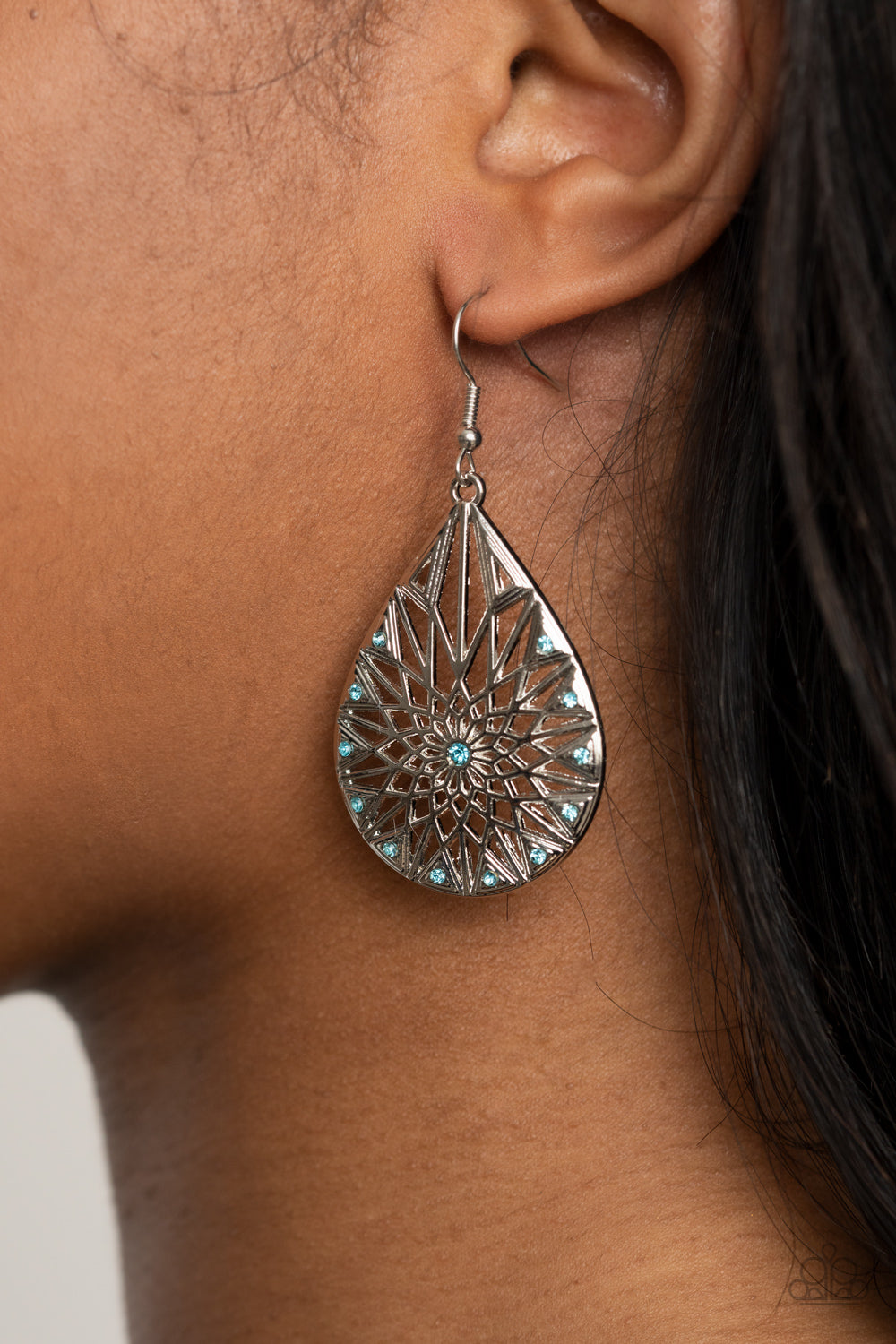 Icy Mosaic Blue Earring - Paparazzi Accessories  Item #P5RE-BLXX-219XX Featuring a shattered snowflake pattern, the front of an airy silver teardrop is adorned in dainty blue rhinestones for an icy finish. Earring attaches to a standard fishhook fitting.  Sold as one pair of earrings.